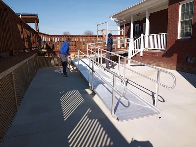 Crews install a temporary wheelchair ramp for Fairmont Police Officer Zackary Hunt at his North Carolina home.