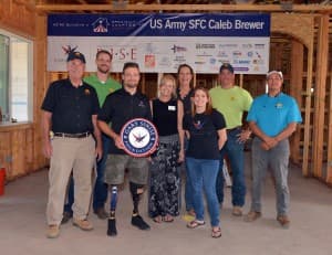 Retired Army Sergeant First Class, Caleb Brewer, and his family during the Walls of Honor event at their soon to be built specially adapted smart home.